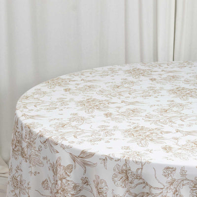 White floral tablecloth on round table in a soft neutral room