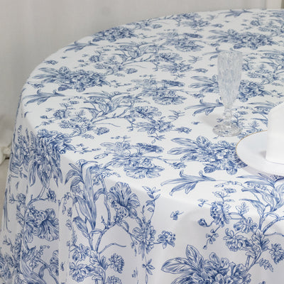 Blue floral tablecloth draped over a round table with glassware.
