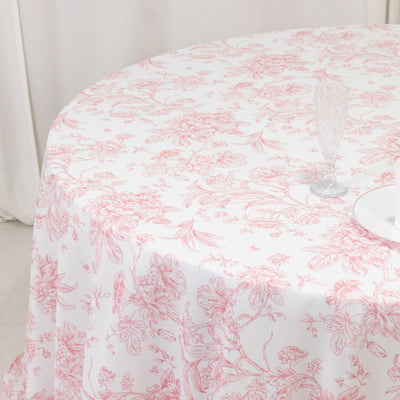 Pink floral tablecloth draped over a round table.