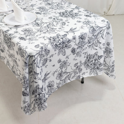 Floral patterned tablecloth draped on a table.