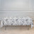 Floral tablecloth draped over a table in a bright, elegant room.