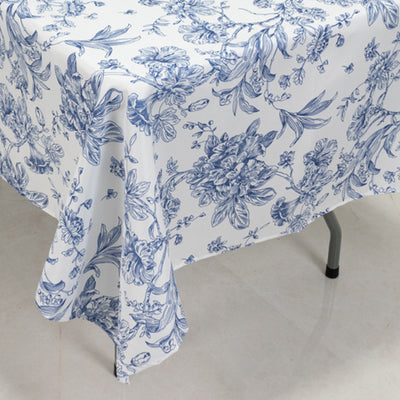 Blue floral print tablecloth draped over a table edge.