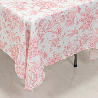 Pink floral tablecloth draped on a table.