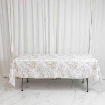 Floral tablecloth on folding table against white curtains
