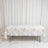Floral tablecloth on folding table against white curtains