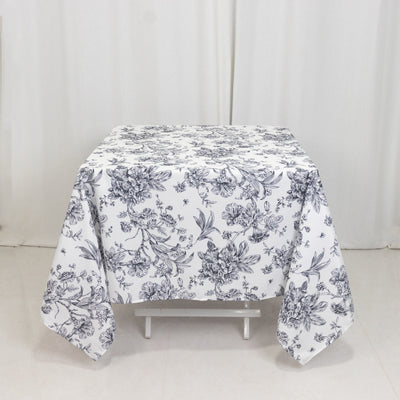 Floral print tablecloth on a table with a plain background.