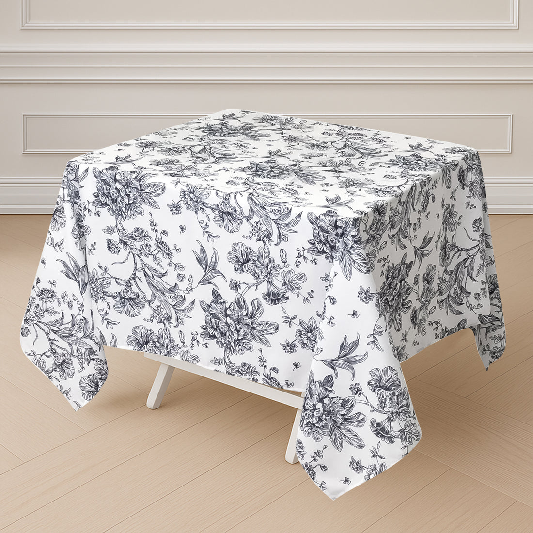 Floral patterned tablecloth on a square table.