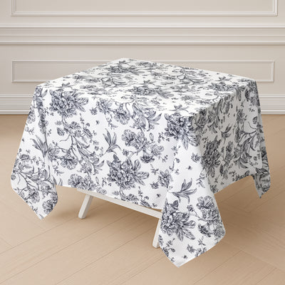 Floral patterned tablecloth on a square table.