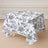 Floral patterned tablecloth on a square table.