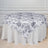 Floral print tablecloth draped over a round table in an elegant setting.