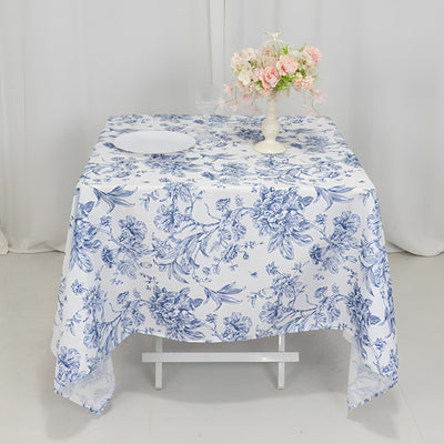 Floral patterned tablecloth with a vase of flowers on a table.