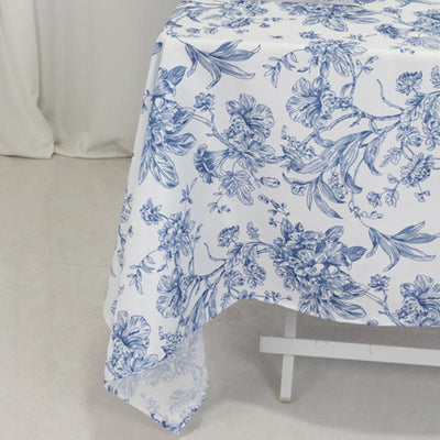 Blue floral tablecloth on a white table with a subtle background.