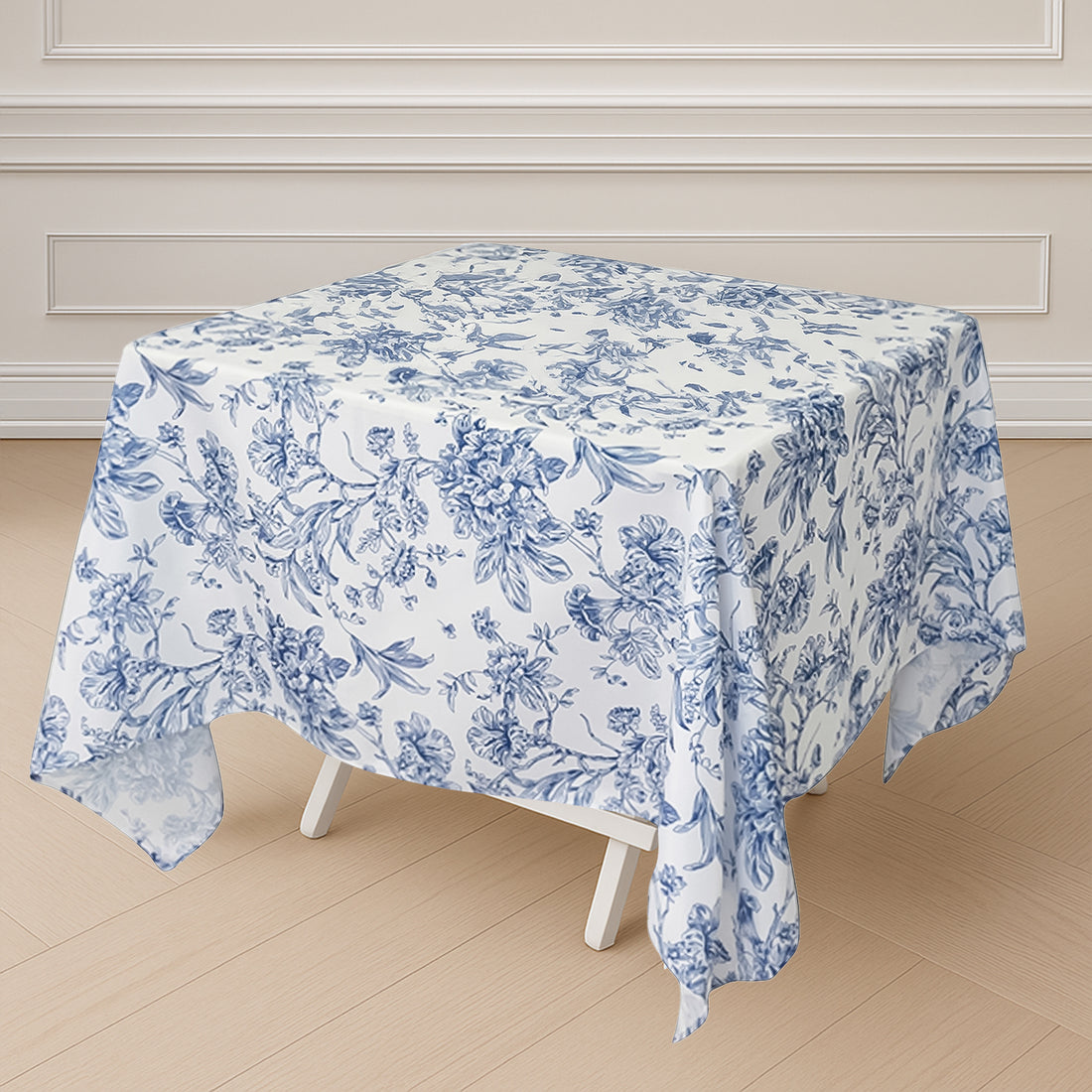 Floral print tablecloth on a square table in a staged setting.