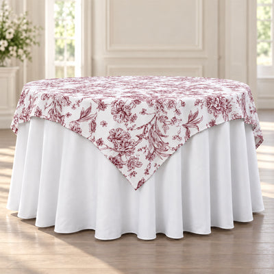 Round table with white floral tablecloth and matching skirt in elegant dining room