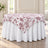 Round table with white floral tablecloth and matching skirt in elegant dining room