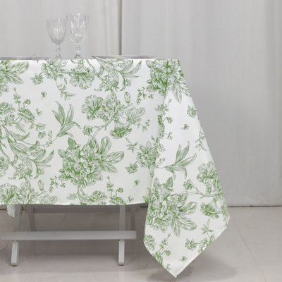 Floral patterned tablecloth with green designs on a white background.
