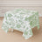 Floral patterned tablecloth draped over a table in a light room.