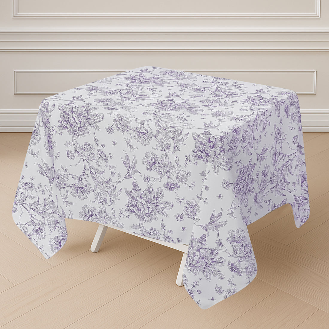 Floral patterned tablecloth draped over a square table.