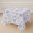 Floral patterned tablecloth draped over a square table.