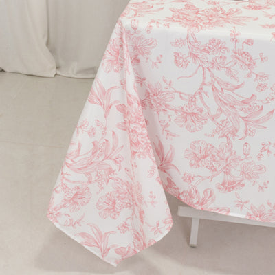Pink floral tablecloth draped on a table.