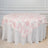 Floral pink and white tablecloth draped over a round table