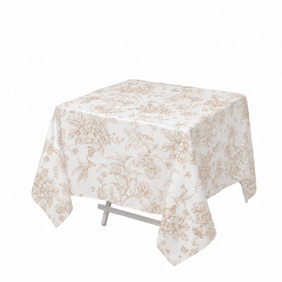 Beige floral tablecloth on a square table with draped corners