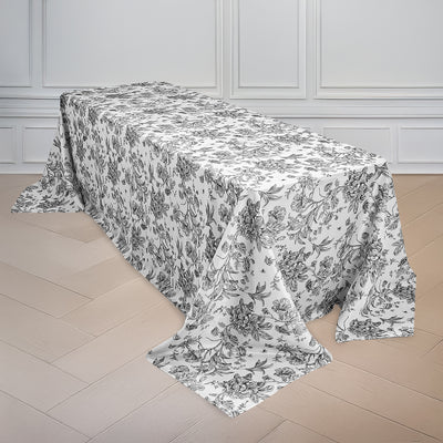 Floral print tablecloth draped over a table in a bright room.