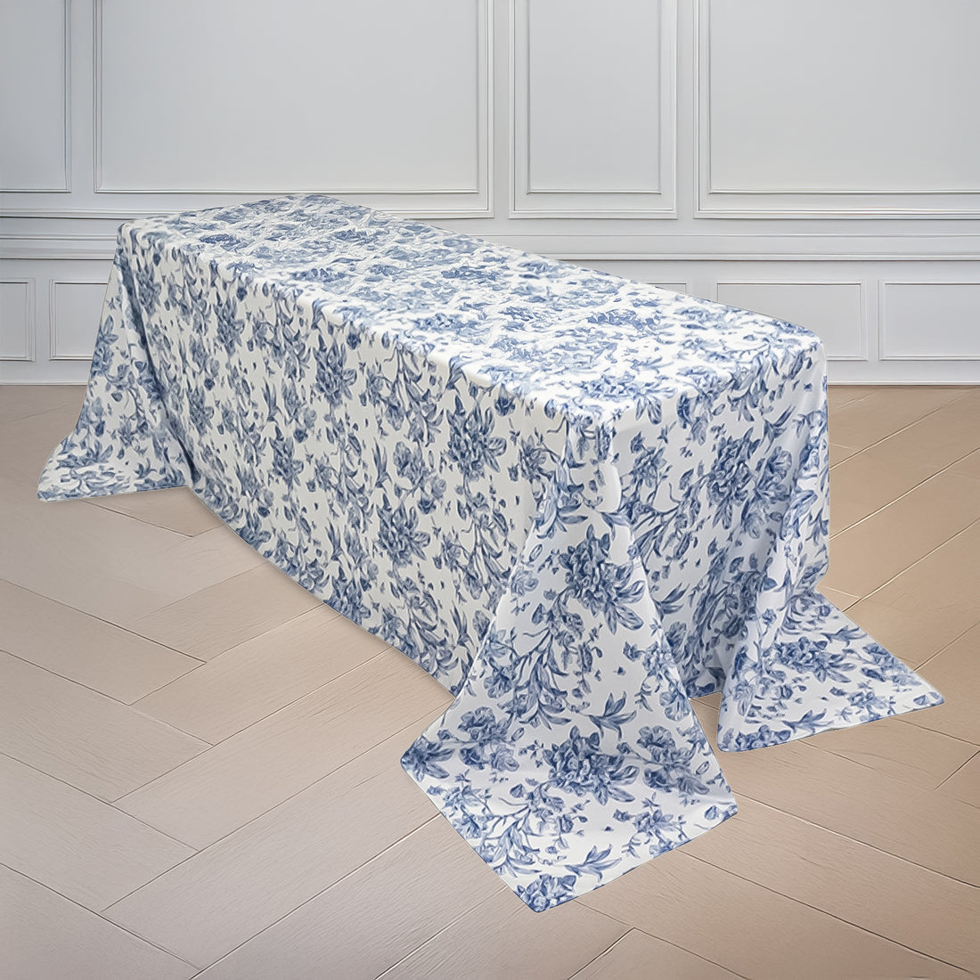 Floral tablecloth in blue and white on a wooden table.