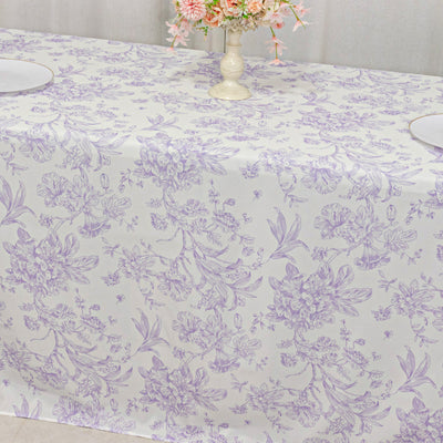 Lavender floral tablecloth on a dining table with a vase of flowers.