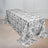 Floral-patterned tablecloth draped over a table in a stylish setting.