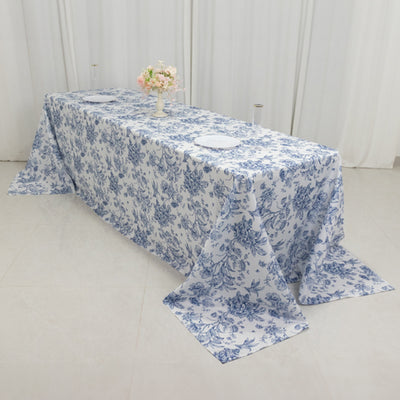Floral blue and white tablecloth draped over a dining table.
