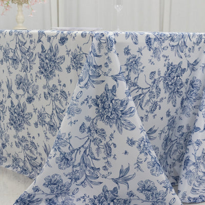 Floral patterned tablecloth in blue and white on a table.