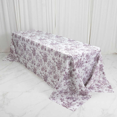 Floral printed tablecloth draped over rectangular table in white room