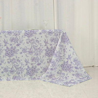 Floral-patterned tablecloth in lavender hues on a table.