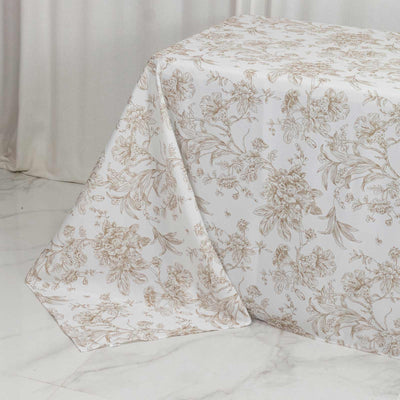 Elegant floral bedspread on a white marble floor in soft neutral tones