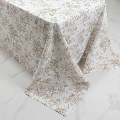 White floral tablecloth with beige botanical print on draped table