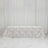 Elegant floral tablecloth on a long table with white draped backdrop