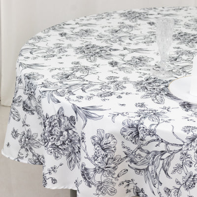 Floral round tablecloth with intricate black and white design.