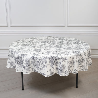Round floral tablecloth with elegant black and white design.