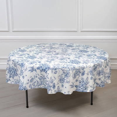 Round floral print tablecloth on a table against a plain background.