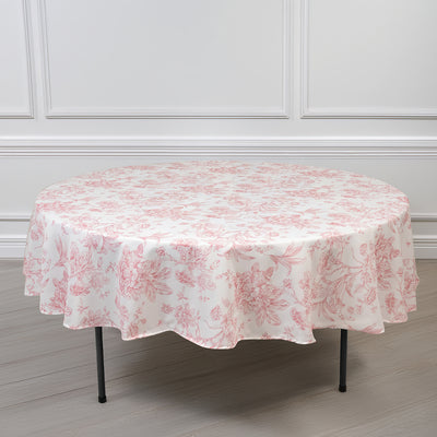 Round floral tablecloth in soft pink and white, elegantly draped on a table.