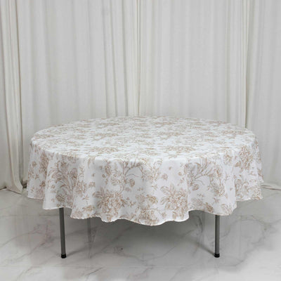 Round floral tablecloth on oval dining table in a minimal white room