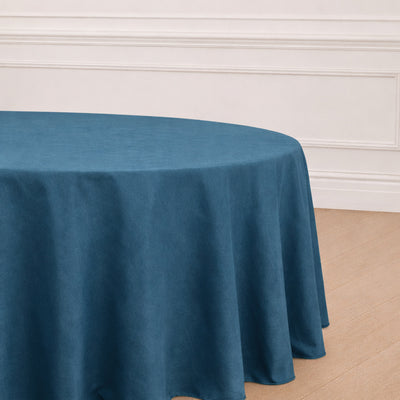 Round blue tablecloth on an elegantly styled table.