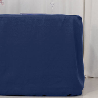 Navy blue tablecloth draped over a table in a simple setting.