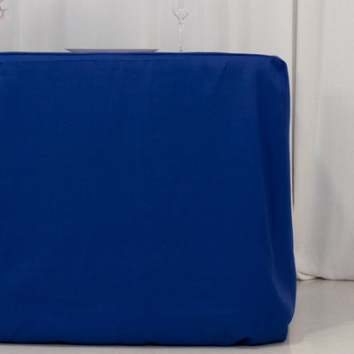 Blue tablecloth draping over a table in a styled setting.