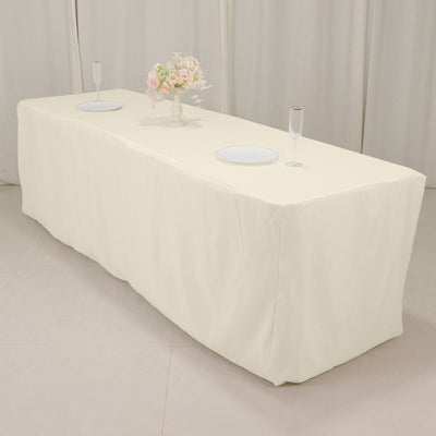 Cream tablecloth draped over a long table with decorative elements.