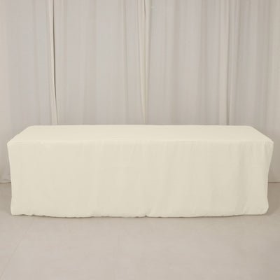 White table cover draped over a table in a studio setting.