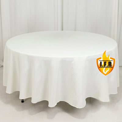 White round tablecloth on a table against a plain backdrop