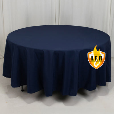 Navy round tablecloth on a table with a plain backdrop