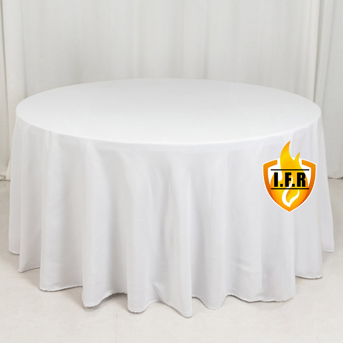 Round white table with a draped tablecloth